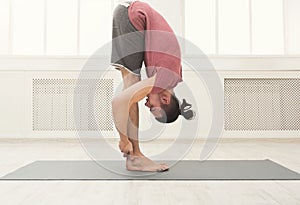 Sporty man doing Standing Forward Bend