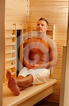 Sporty man enjoying sauna