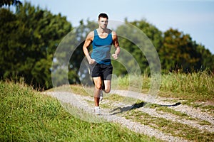 Sporty, man and jogging in nature for fitness, health and wellness in outdoor for workout or exercise. Male athlete