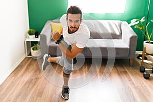 Sporty man practicing HIIT at home