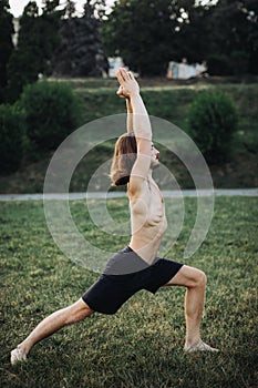 Sporty man practicing yoga outdoor