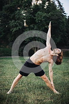 Sporty man practicing yoga outdoor