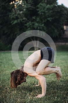 Sporty man practicing yoga outdoor