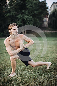 Sporty man practicing yoga outdoor