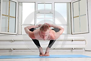 Sporty man practicing yoga. Squat, Garland pose, Malasana