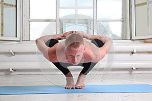 Sporty man practicing yoga. Squat, Garland pose, Malasana