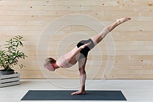 Sporty man practicing yoga, warrior pose