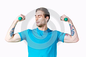 sporty man with pumped up arms dumbbells workout tattoo cropped view