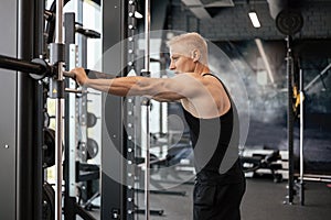 Sporty man resting, having break drinking water after doing exercise.