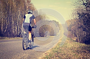 Sporty Man Riding a Bicycle on the Road