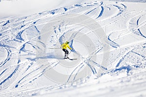 Sporty man skiing downhill in high mountains