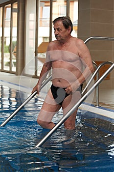 Sporty mature man going swimming