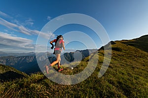 Sporty mountain woman rides in trail during endurance trail photo
