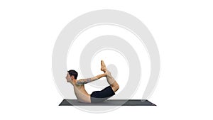 Sporty muscular young yogi man doing backbend exercise, dhanuras