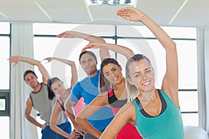 Sporty people doing power fitness exercise at yoga class