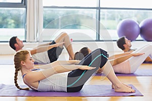 Sporty people stretching hands at yoga class