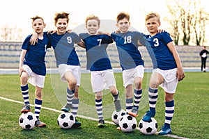 Sporty School Boys in Soccer Team. Group of Children in Football Jersey Sportswear Standing with Balls on Grass Pitch
