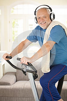 Sporty senior listening to music while exercising