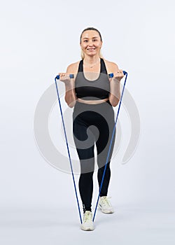 Sporty senior woman with fitness exercising rope. Clout