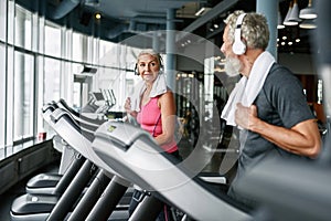 Sporty seniors exercising together in modern gym