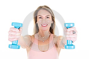 Sporty slim young blonde woman with blue dumbbells on white background