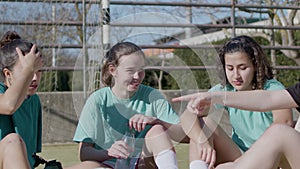 Sporty teenaged girls having rest after tiresome training