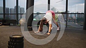 Sporty woman in activewear doing exercise in gym