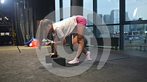 Sporty woman in activewear doing exercise in gym