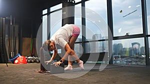 Sporty woman in activewear doing exercise in gym