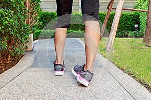 Sporty woman ankle sprain while jogging or running at park.