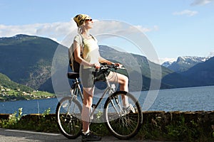 Sporty woman on a bicycle trip in the mountains 2