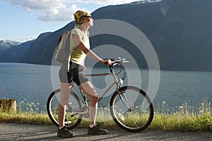 Sporty woman with bike in the mountains