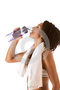 Sporty woman with bottle of water and towel