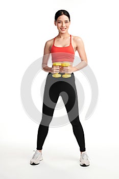 Sporty woman does the exercises with dumbbells on white background, Strength and motivation