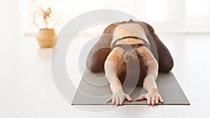 Sporty Woman Doing Child Exercise, Balasana Pose photo