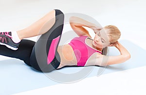 Sporty woman doing exercise on the floor