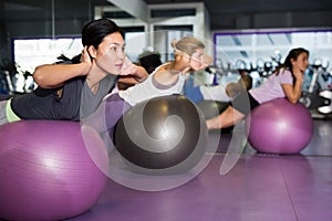 Sporty woman doing exercises with fit ball