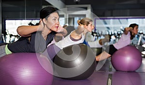Sporty woman doing exercises with fit ball