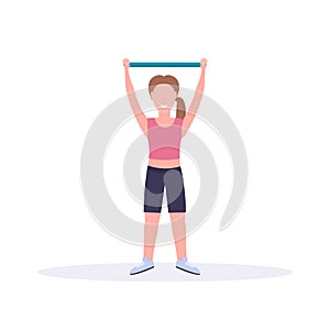 Sporty woman doing exercises with resistance band girl training in gym stretching workout healthy lifestyle concept flat