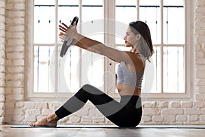 Young sporty attractive woman practicing pilates with a ring photo