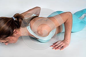 sporty woman doing push-ups in the gym on a white background.