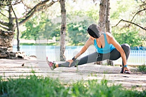 Sporty woman doing stretching exercise