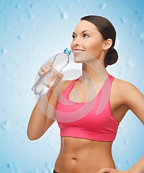 Sporty woman drinking water from bottle