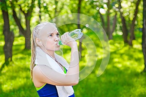 Sporty woman drinking water outdoor