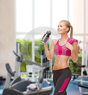 Sporty woman drinking water from sportsman bottle