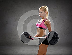 Sporty woman exercising with barbell