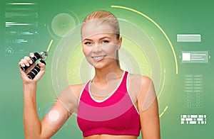 Sporty woman with expander over green background