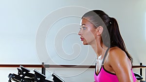 Sporty woman at the gym on bike. Sunny gym