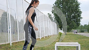 Sporty woman in gym doing cross fit exercise step up on box