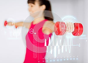 Sporty woman hands with light red dumbbells